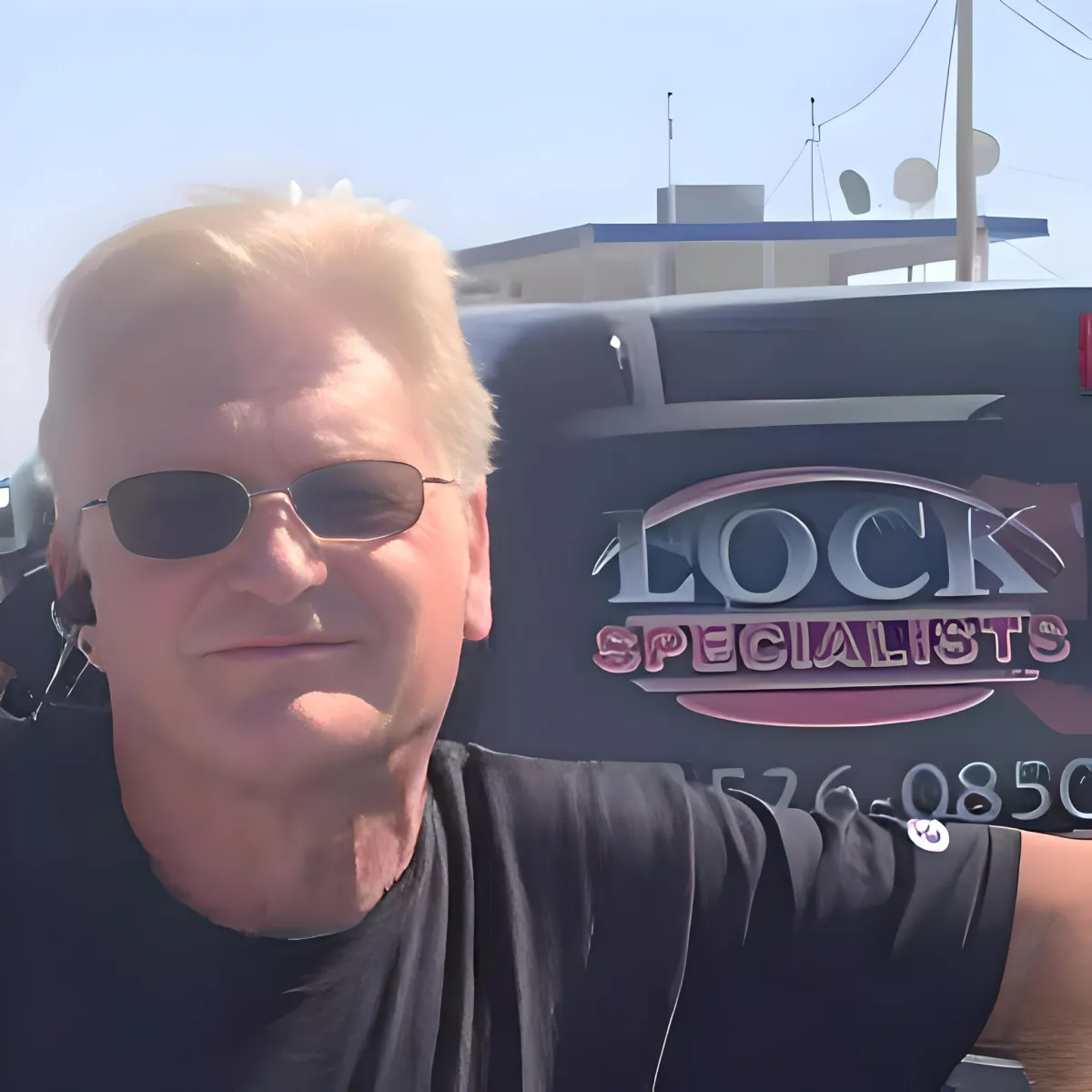 Dennis Murphy, owner of Lock Specialists, standing beside the company service van in Simi Valley
